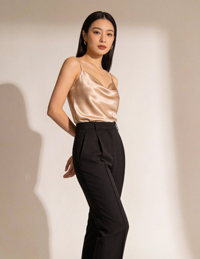 Woman wearing champagne satin camisole top